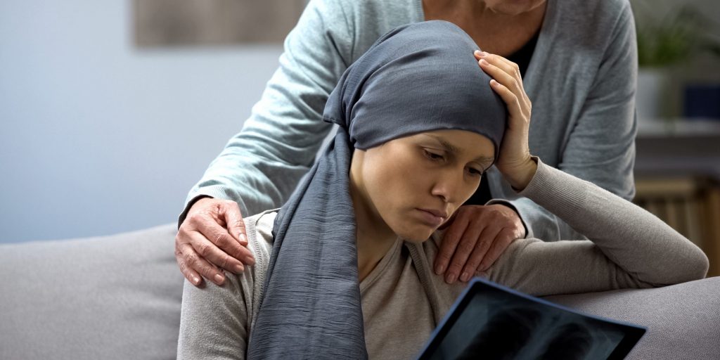 Woman with cancer looking at x-ray